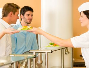 People getting served food in a canteen