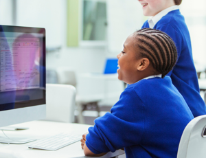 students learning and looking at a computer