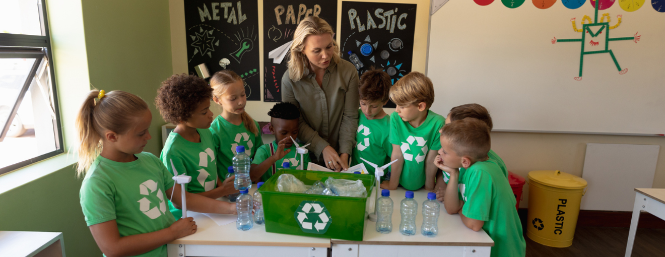 children in a classroom with recycling graphics