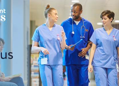 Healthcare staff walking through a hospital corridor wearing medical scrubs